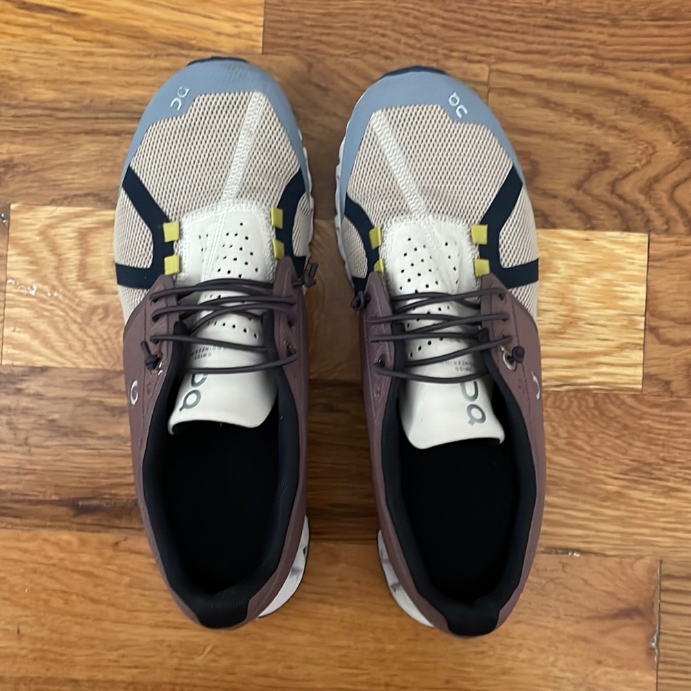 On Running Sneakers in Cream, Brown, and Blue with Yellow Accents